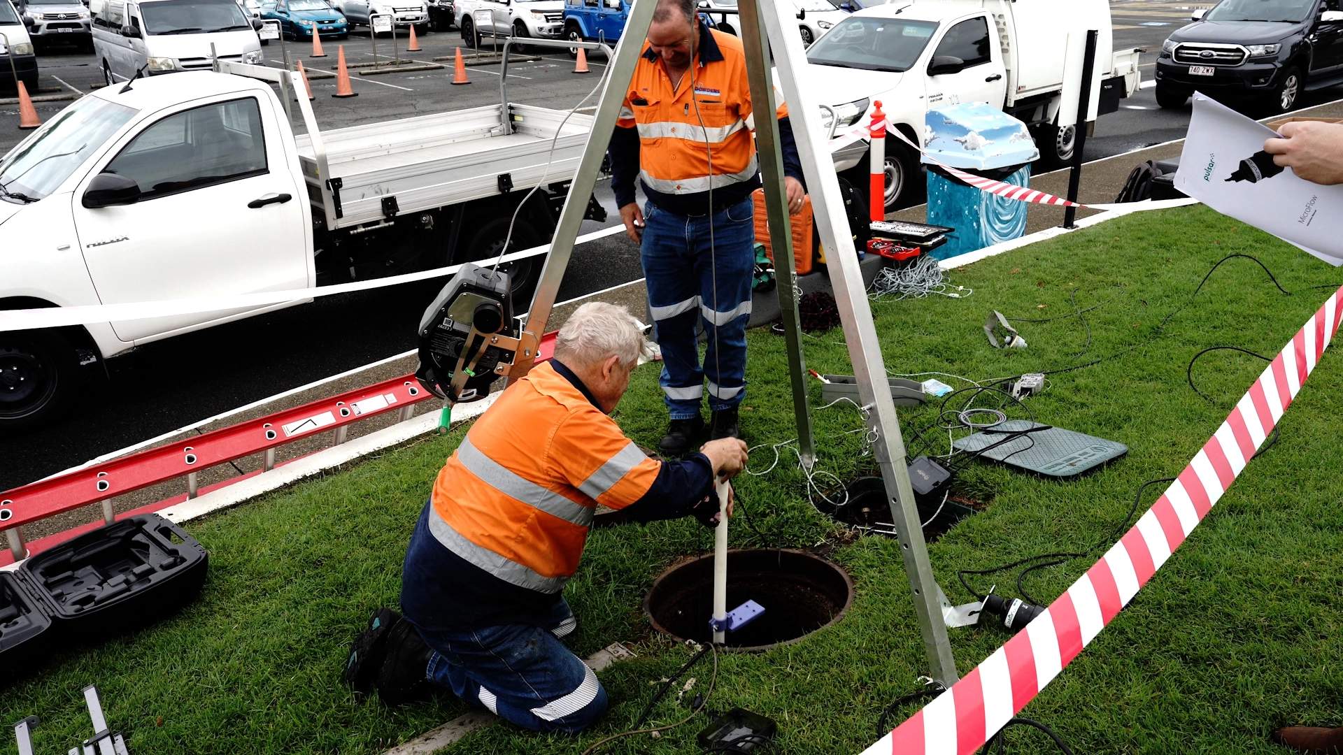 Sea World installers going down a sewer pit