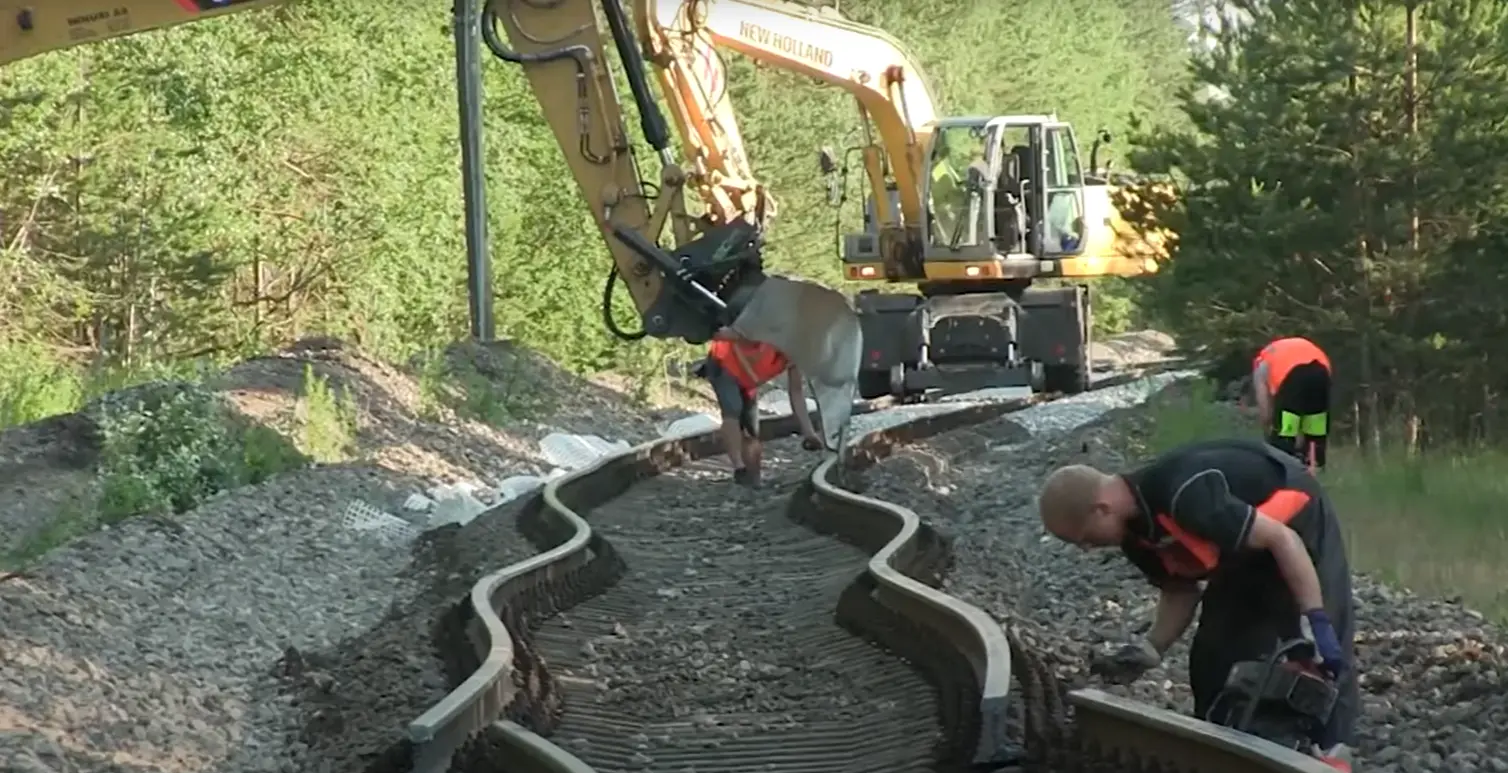 Rail workers fix a buckled track